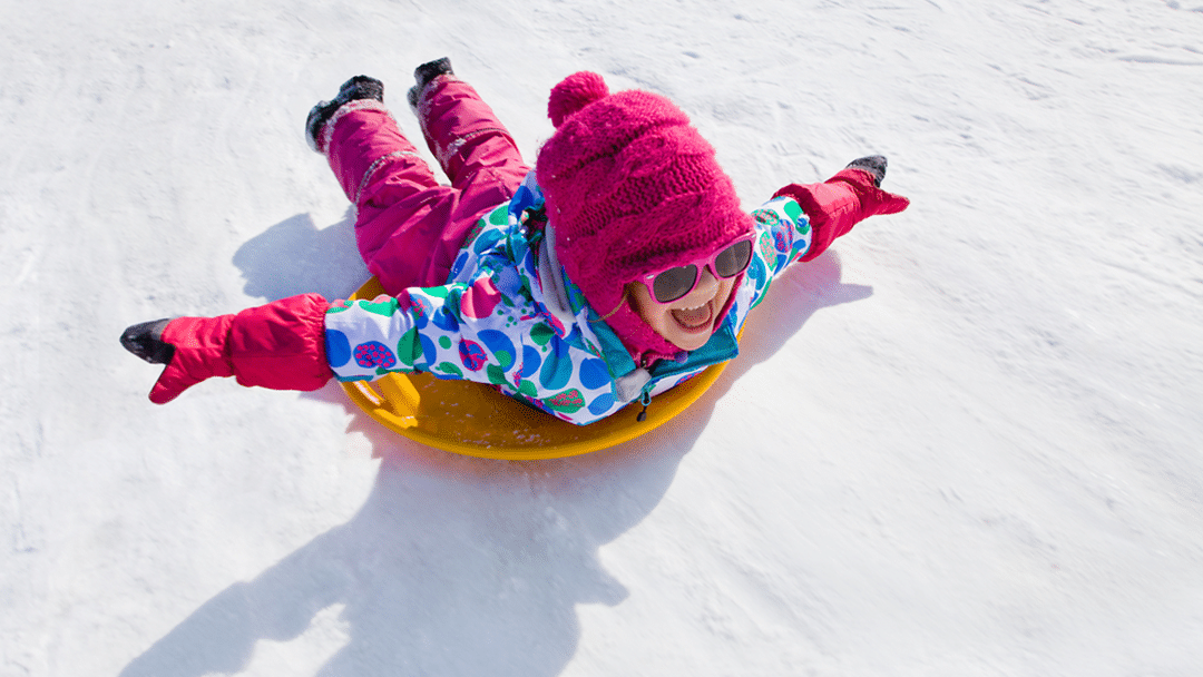 Young girl sledding in Finland