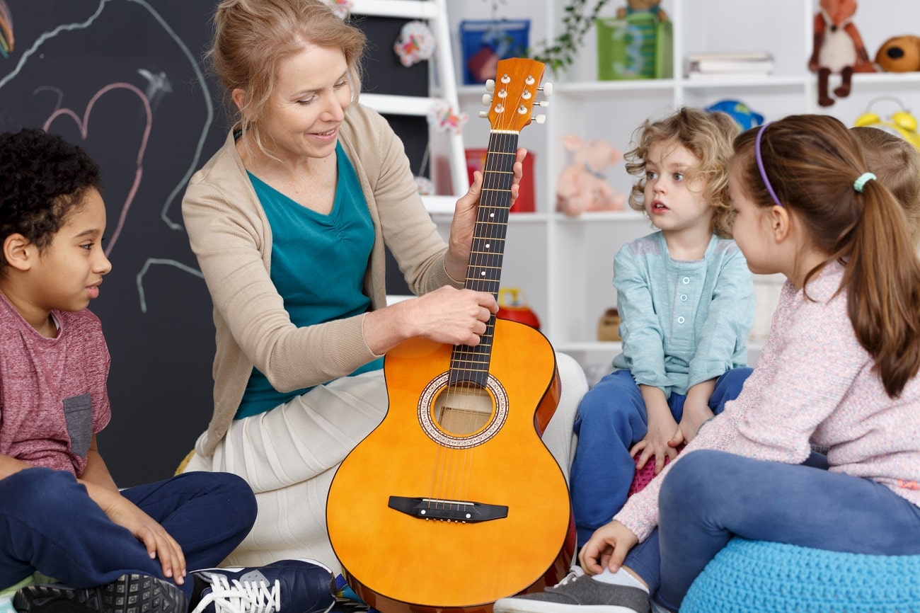 School teacher plays guitar for class