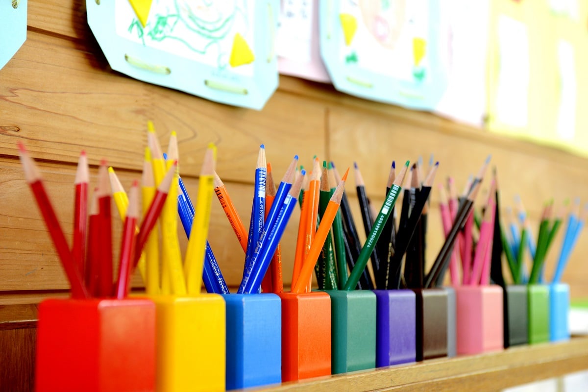 a row of different coloured pencil pots