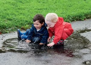 emotional regulation - children playing in a puddle - developing emotional regulation
