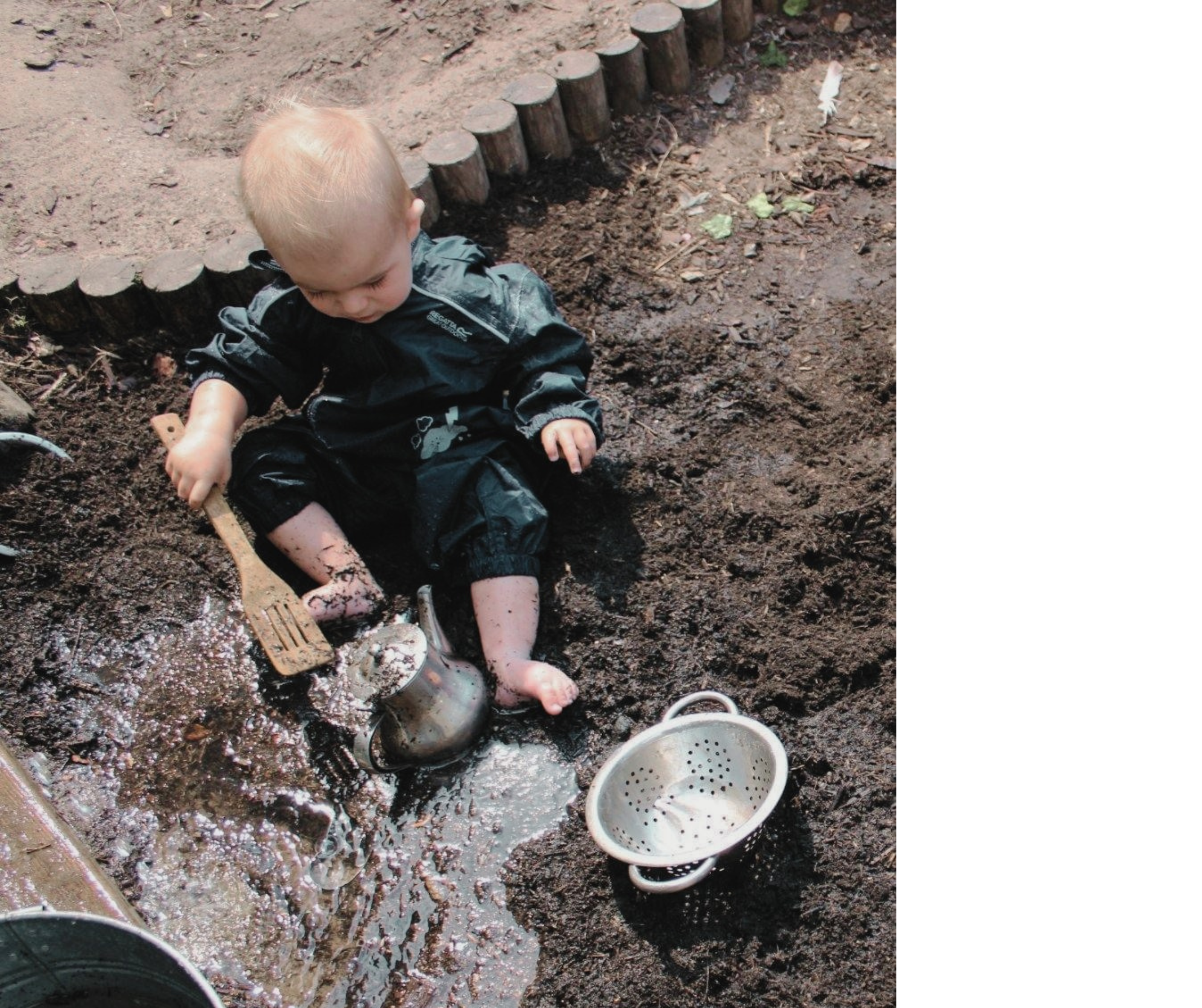 Child playing outdoors in the mud