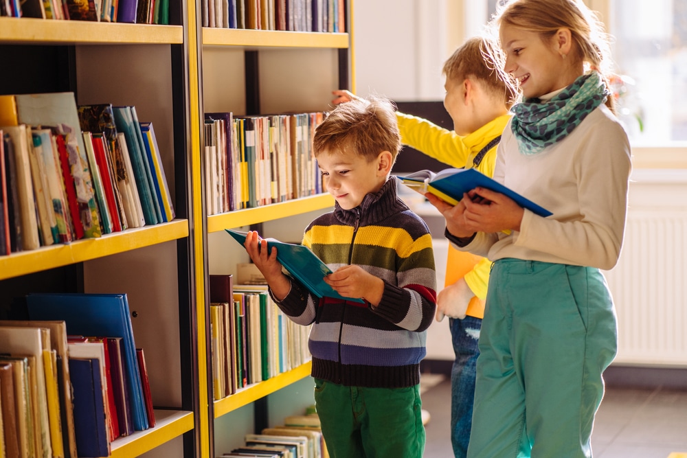 Guide to national storytelling week- children choosing books at library