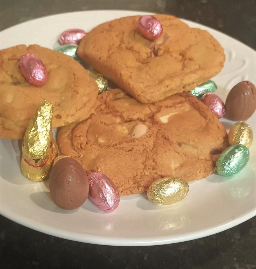 Spring desserts- cookies served on a plate with easter eggs and rabbit around them