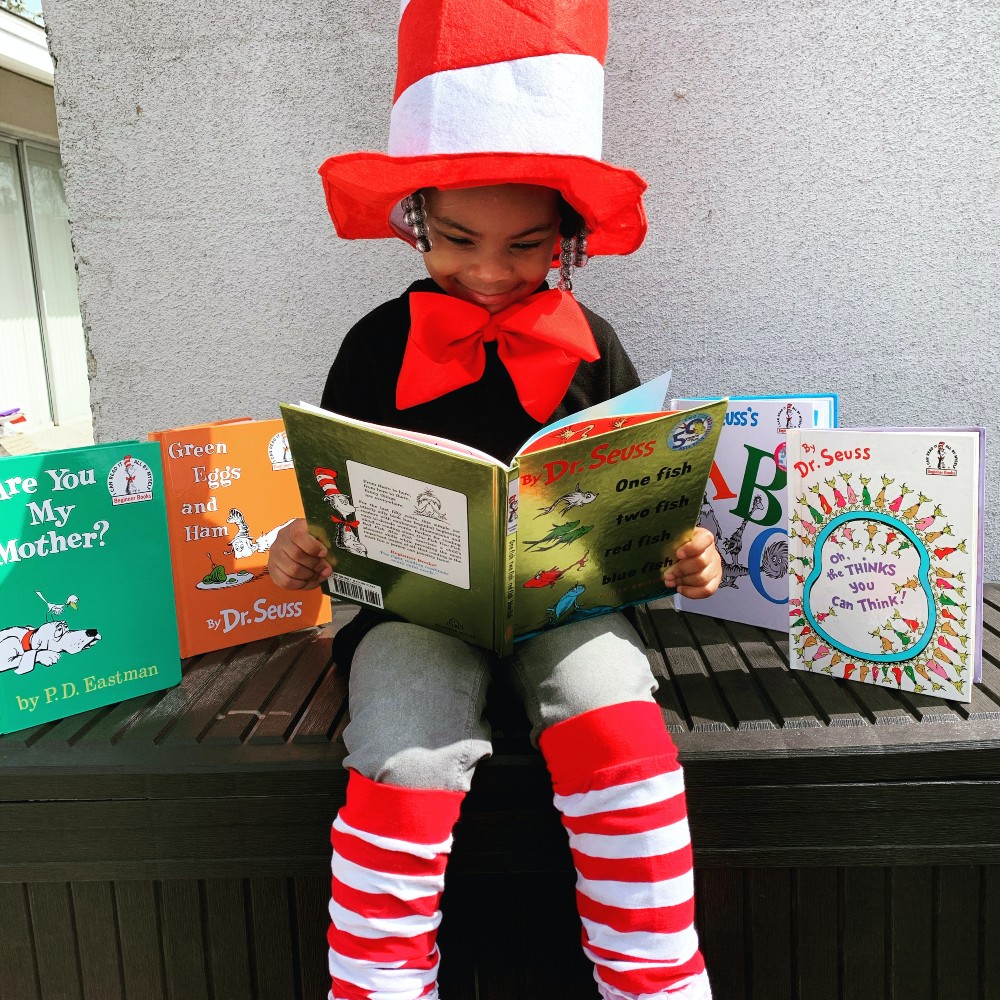 Dr Suess quotes- girl reading Dr Suess books