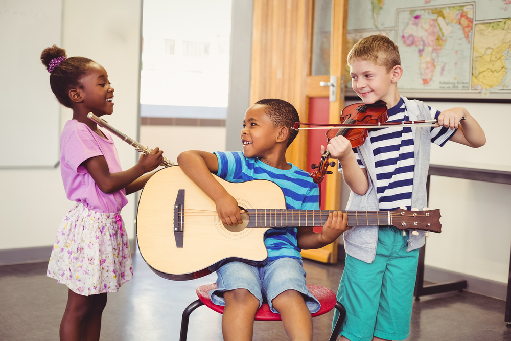 Benefits of learning an instrument- children learning an instrument in class and socialising