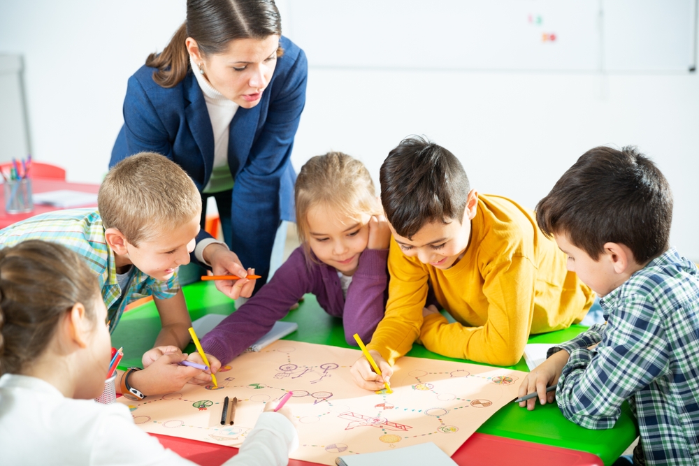 Writing games- children playing a writing game in groups