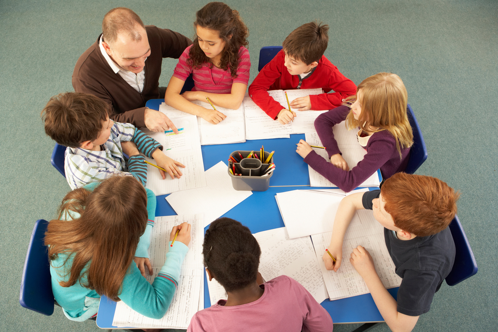 Children's writing tips- pupils working together on a wriing activity with teacher