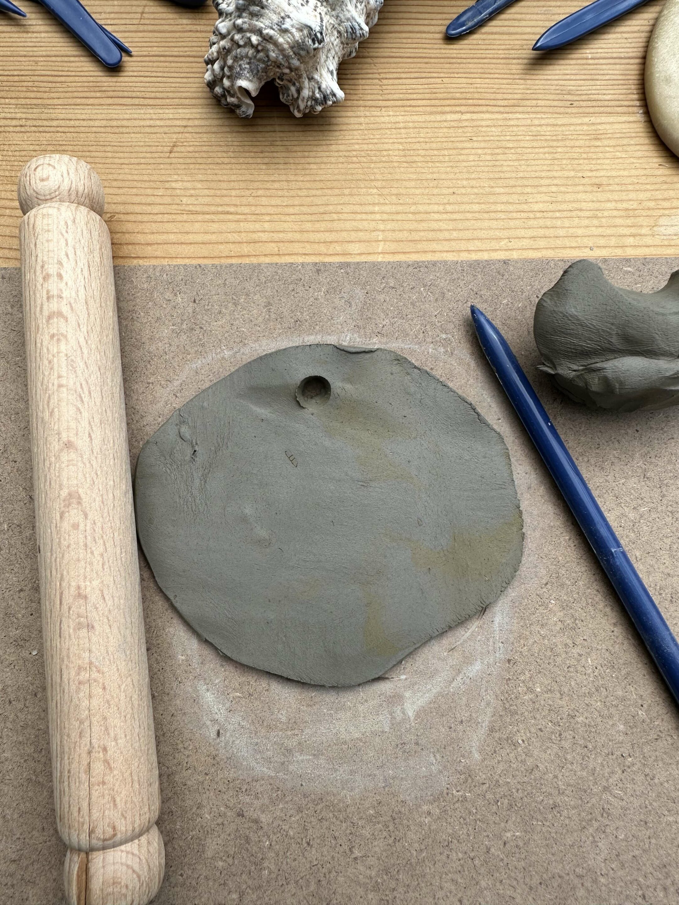 rolled out clay with small hole