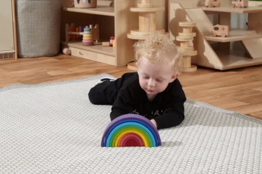 child with sustainable silicone rainbow stacker
