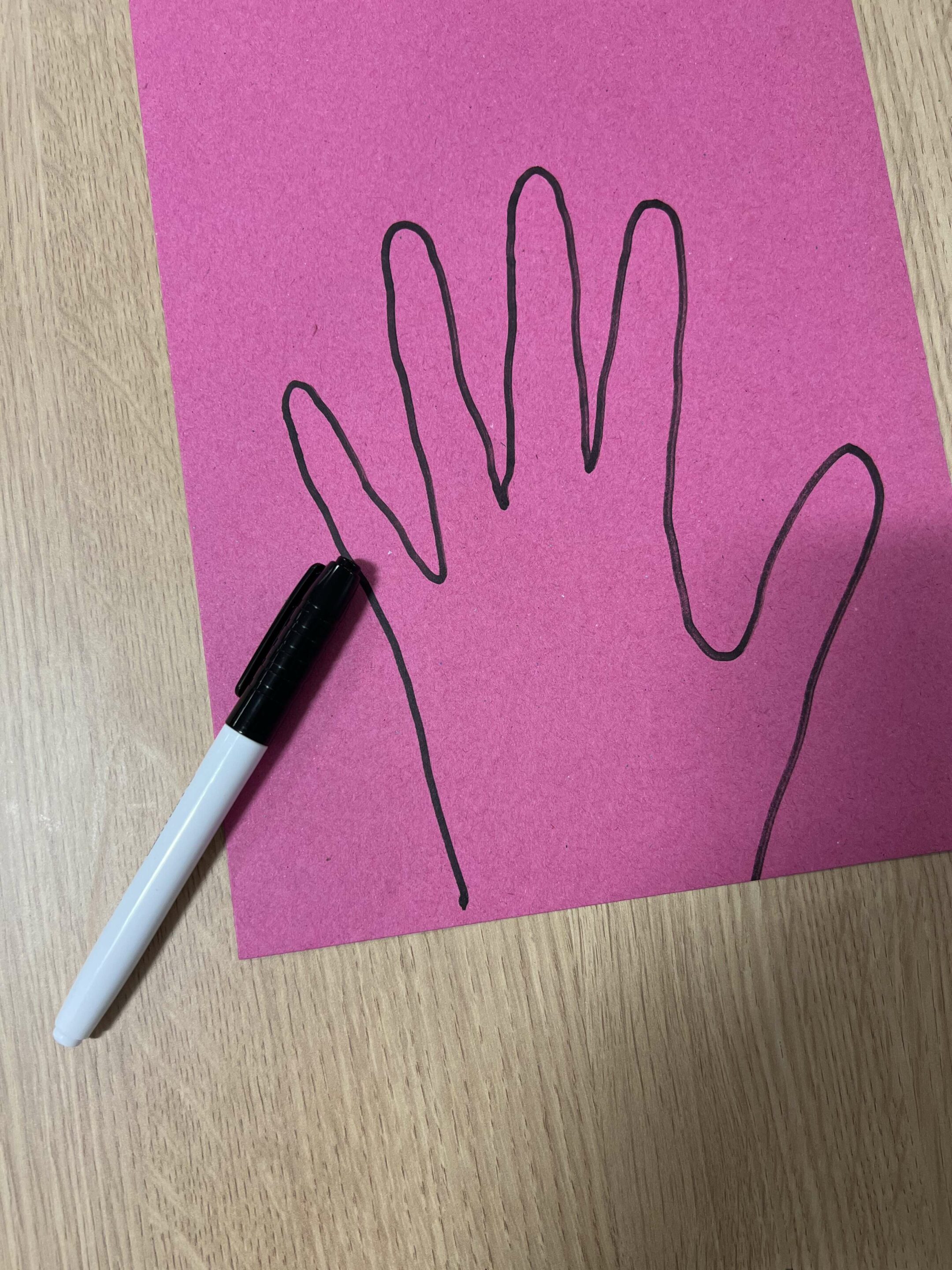 handprint trace on piece of coloured paper