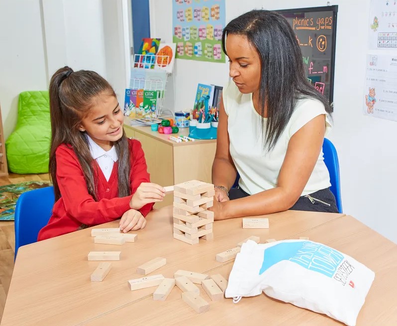 How to build self-esteem in children- teacher and child playing talking tower