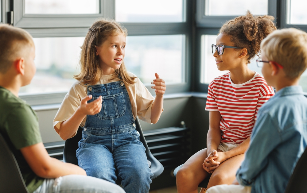 How to build self esteem in children- child talking to peers