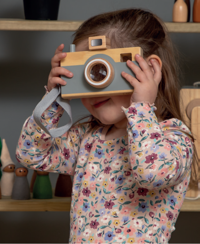 Girl, taking photo with wooden toy camera