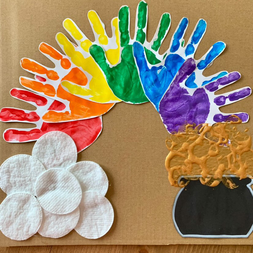 St Patrick's Day craft with rainbow handprints, pot of gold and clouds