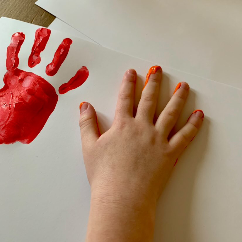 making a hand print to cut out